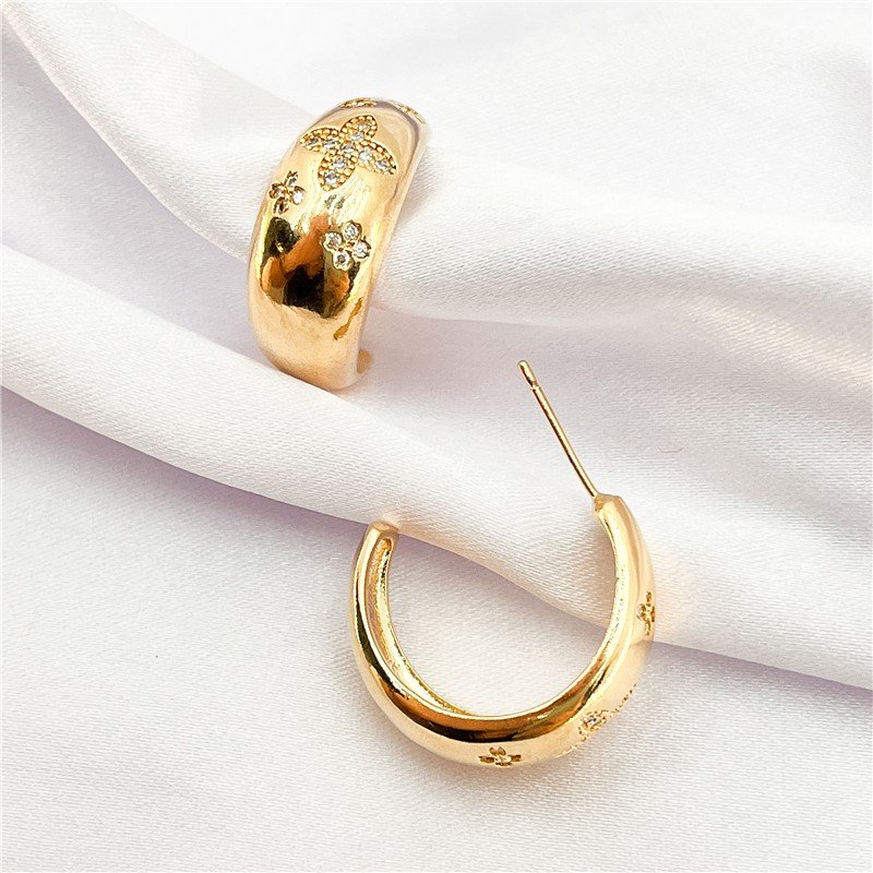 BRINCO MEIA ARGOLA COM TREVO FOLHEADO A OURO